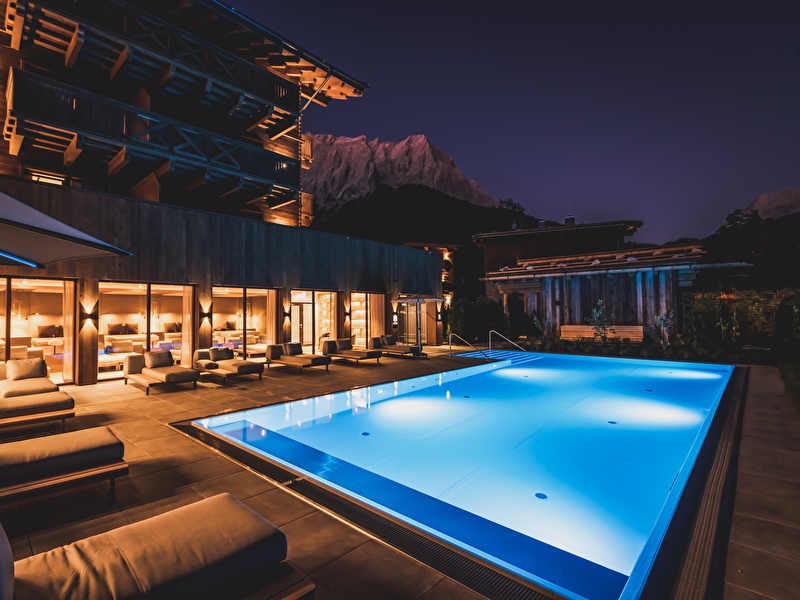 Outdoor heated pool with lounge beds 